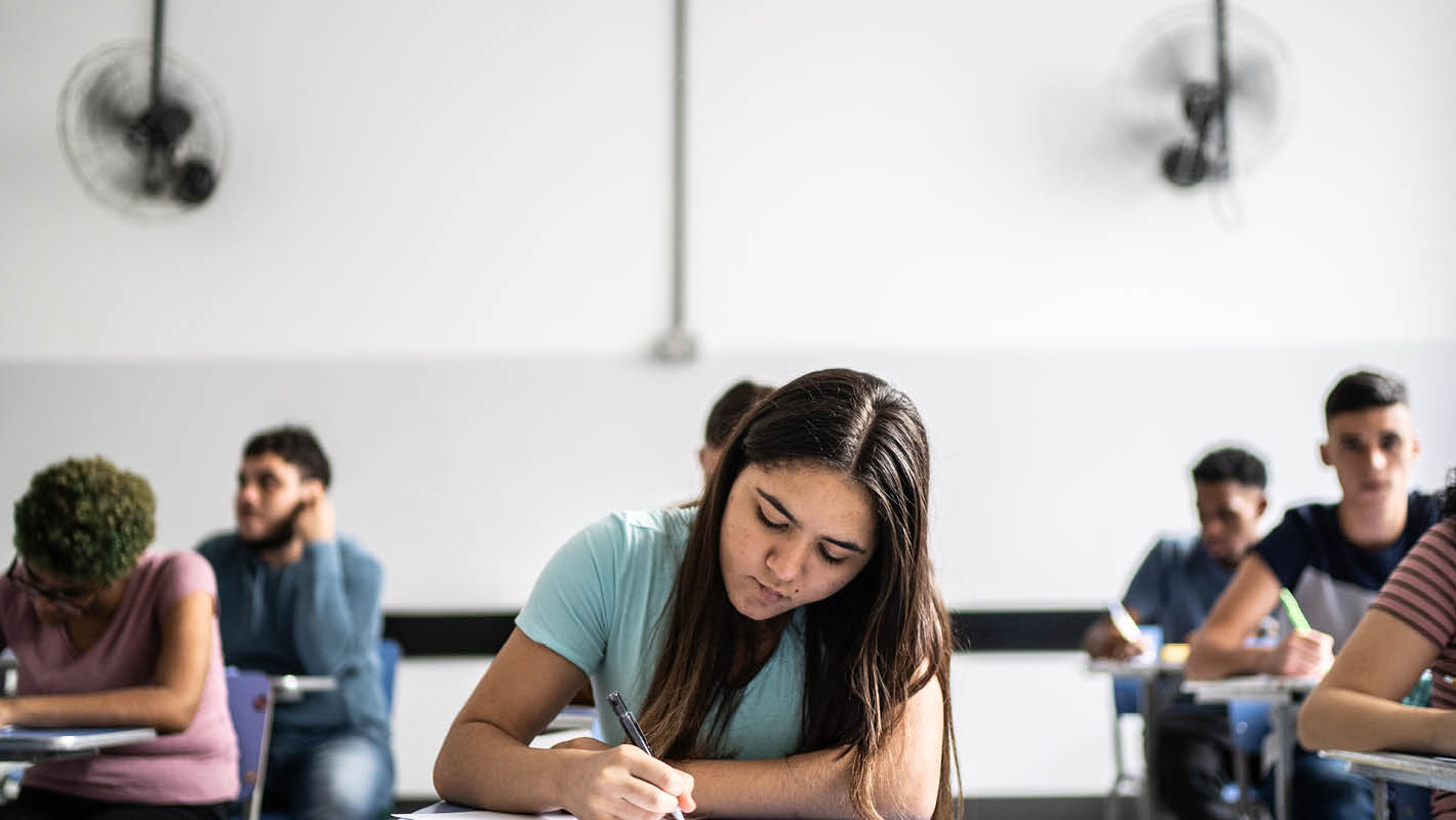 Estudantes fazem prova em sala de aula.
